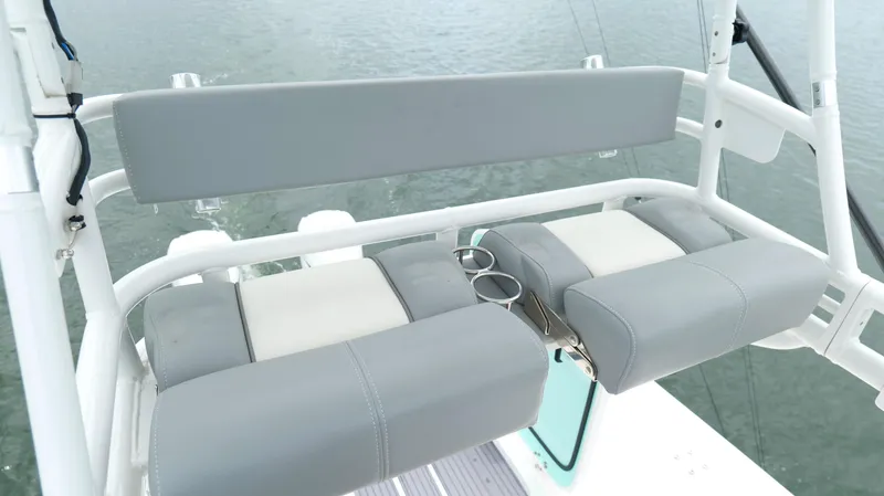 Slide: The Image of 2023 Everglades 365 CC boat seating with cup holders on a calm water backdrop. - 23