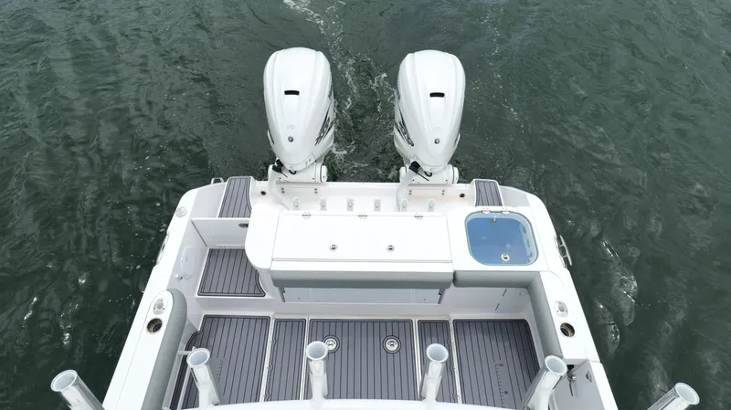 Slide: The Image of 2023 Everglades 365 CC boat with dual engines on water. - 25