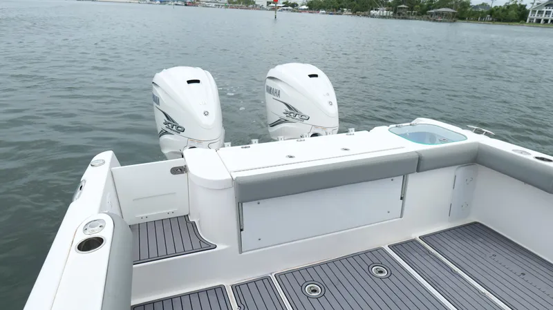 Slide: The Image of 2023 Everglades 365 CC boat with twin Yamaha engines on calm water. - 26