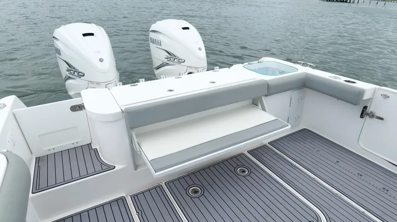 Slide: The Image of 2023 Everglades 365 CC boat with Yamaha engines, featuring a spacious deck and seating area. - 27