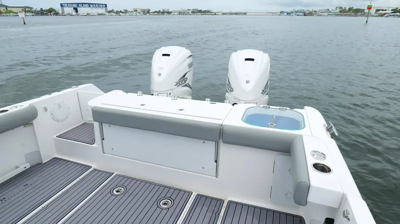 Slide: The Image of 2023 Everglades 365 CC boat with dual engines, docked at Treasure Island Marina. - 28