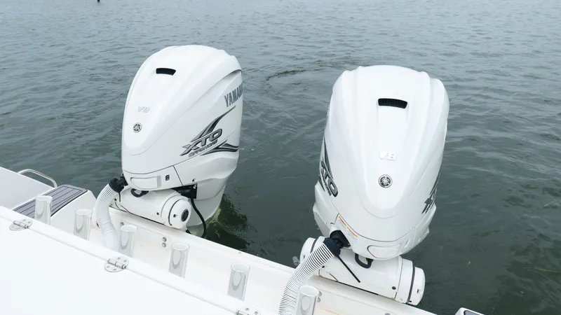 Slide: The Image of Twin Yamaha outboard engines on a 2023 Everglades 365 CC boat in water. - 29