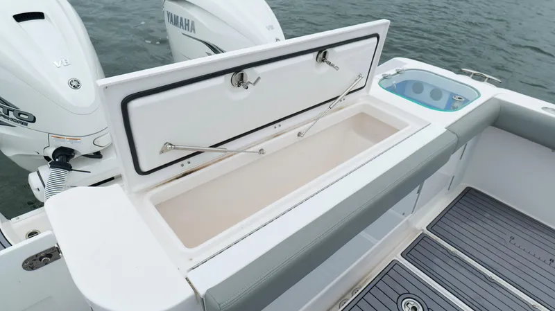 Slide: The Image of 2023 Everglades 365 CC boat with open storage compartment and Yamaha engines. - 30