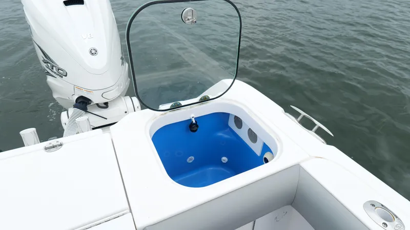 Slide: The Image of 2023 Everglades 365 CC boat with open livewell and Yamaha outboard engine. - 31