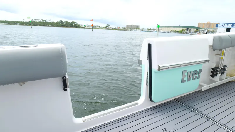 Slide: The Image of 2023 Everglades 365 CC boat with open side door on calm water. - 32