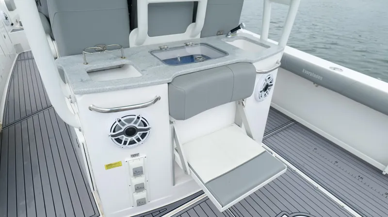 Slide: The Image of 2023 Everglades 365 CC boat interior with seating, speakers, and storage compartments. - 33