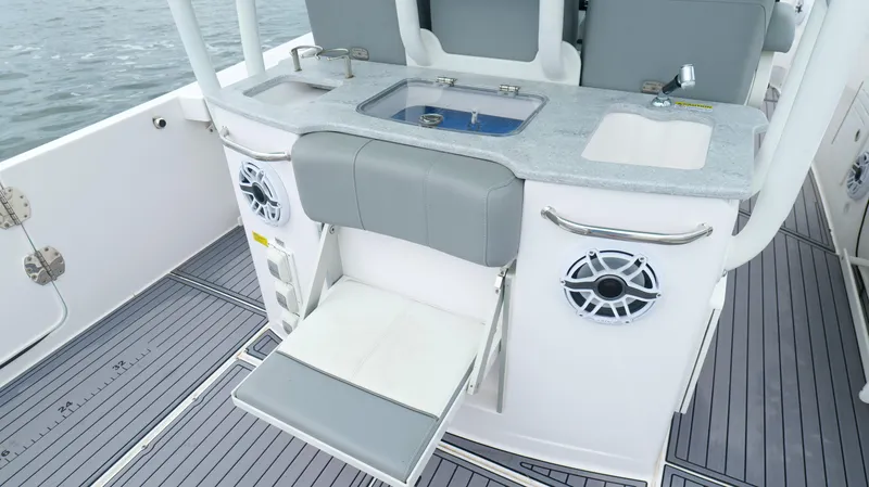 Slide: The Image of 2023 Everglades 365 CC boat interior with sink, seating, and speaker system. - 34