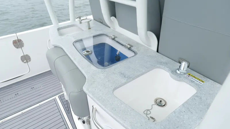 Slide: The Image of 2023 Everglades 365 CC boat with dual sinks and seating on deck. - 35
