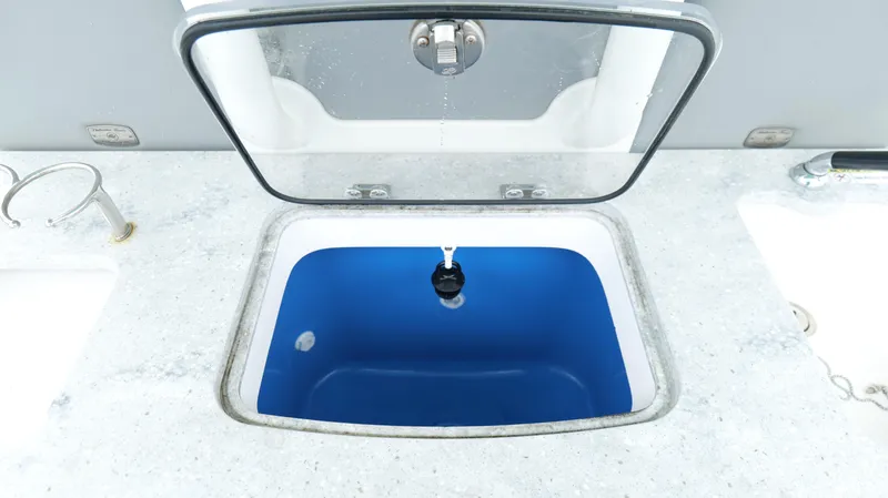 Slide: The Image of Open livewell on 2023 Everglades 365 CC boat, featuring a blue interior. - 36