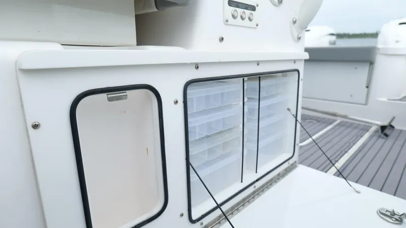 Slide: The Image of Storage compartments on a 2023 Everglades 365 CC boat deck. - 38