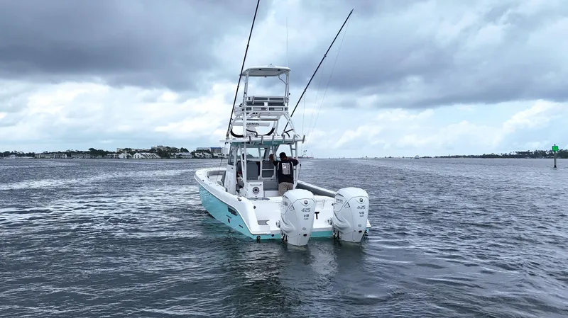 Slide: The Image of 2023 Everglades 365 CC boat on water with dual engines, cloudy sky. - 4
