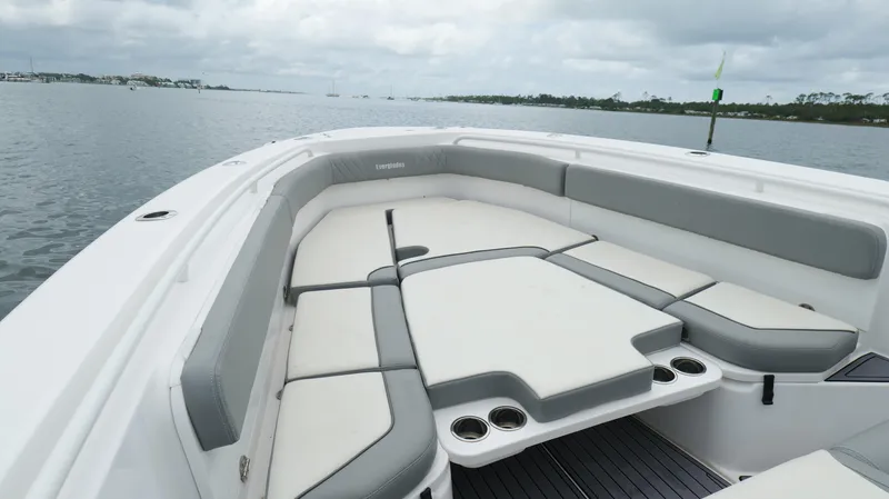 Slide: The Image of 2023 Everglades 365 CC boat with spacious seating on a calm water backdrop. - 43