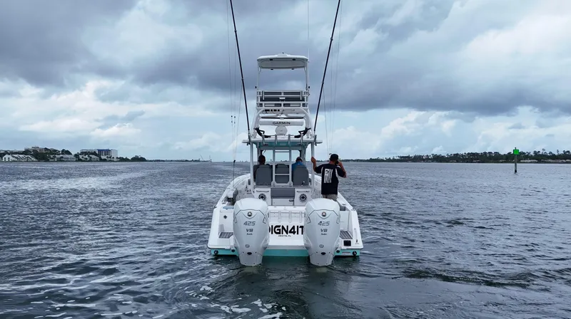 Slide: The Image of 2023 Everglades 365 CC boat on water under cloudy sky. - 5