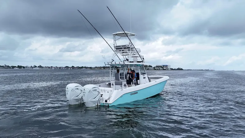 Slide: The Image of 2023 Everglades 365 CC boat on water under cloudy sky. - 6