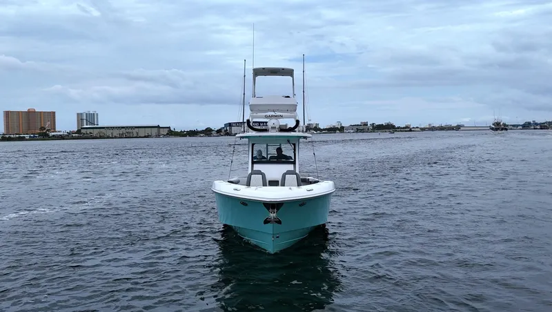 Slide: The Image of 2023 Everglades 365 CC boat on open water under cloudy sky. - 9