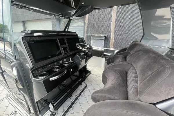 Slide: The Image of Interior of 2019 Nor-Tech 450 Sport Center Console with modern dashboard and plush seating. - 12