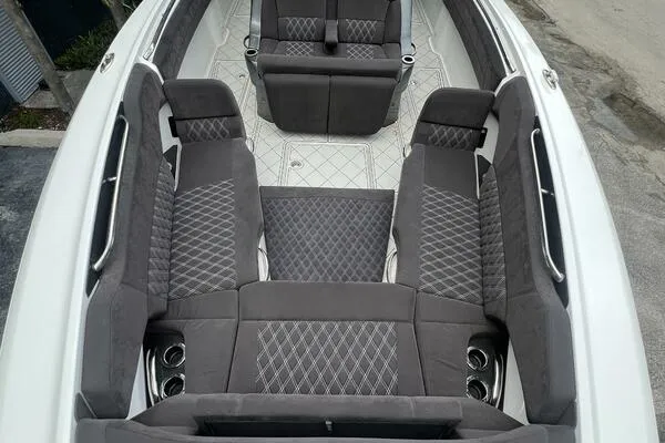 Slide: The Image of 2019 Nor-Tech 450 Sport Center Console with luxurious gray seating and diamond stitching. - 18