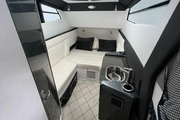 Slide: The Image of Interior of 2019 Nor-Tech 450 Sport Center Console with seating and kitchenette. - 21