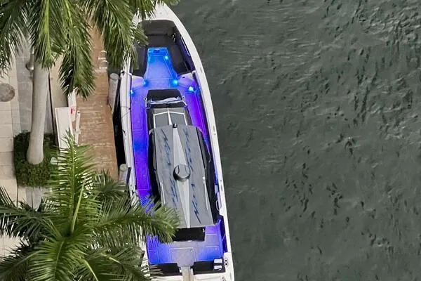Slide: The Image of Aerial view of 2019 Nor-Tech 450 Sport Center Console boat with vibrant blue lighting. - 24