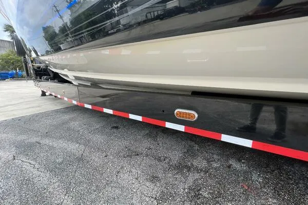 Slide: The Image of 2019 Nor-Tech 450 Sport Center Console boat on a trailer, side view. - 27