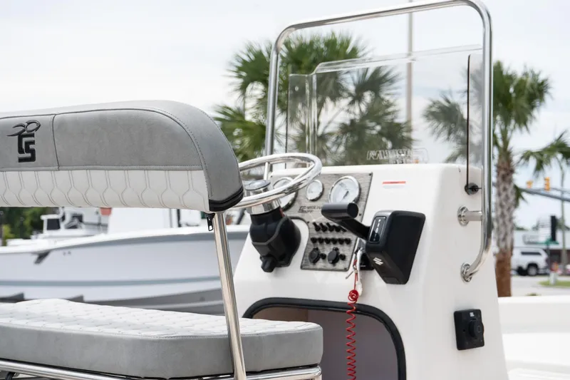Slide: The Image of 2025 Carolina Skiff E16 JVX CC boat console with steering wheel and controls. - 5