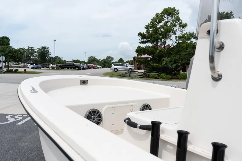 Slide: The Image of 2025 Carolina Skiff E16 JVX CC boat parked, showcasing deck and console details. - 7