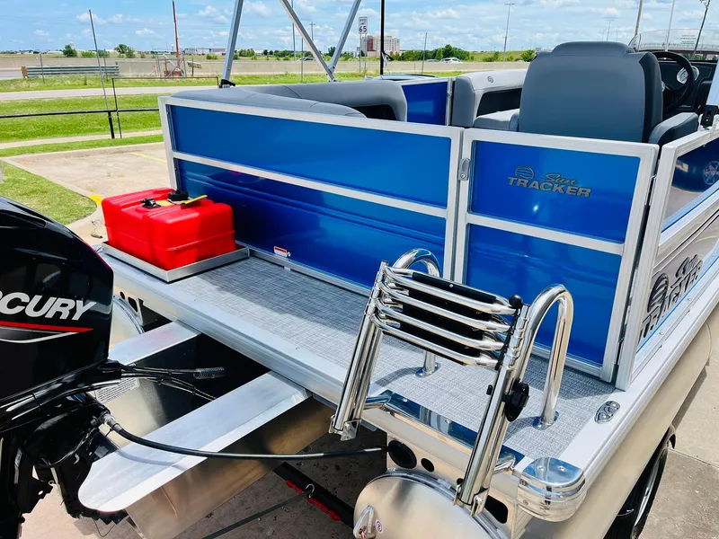 Slide: The Image of 2026 Sun Tracker Party Barge 16 DLX pontoon boat with Mercury engine and red fuel tank. - 10