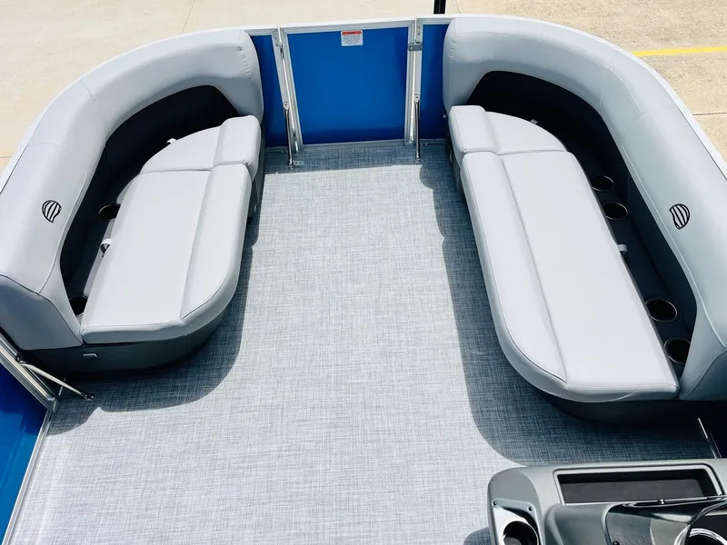 Slide: The Image of 2026 Sun Tracker Party Barge 16 DLX interior with gray seating and cup holders. - 15