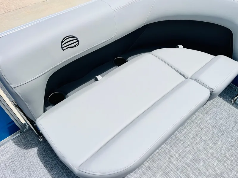 Slide: The Image of 2026 Sun Tracker Party Barge 16 DLX, featuring sleek gray seating and cup holders. - 17