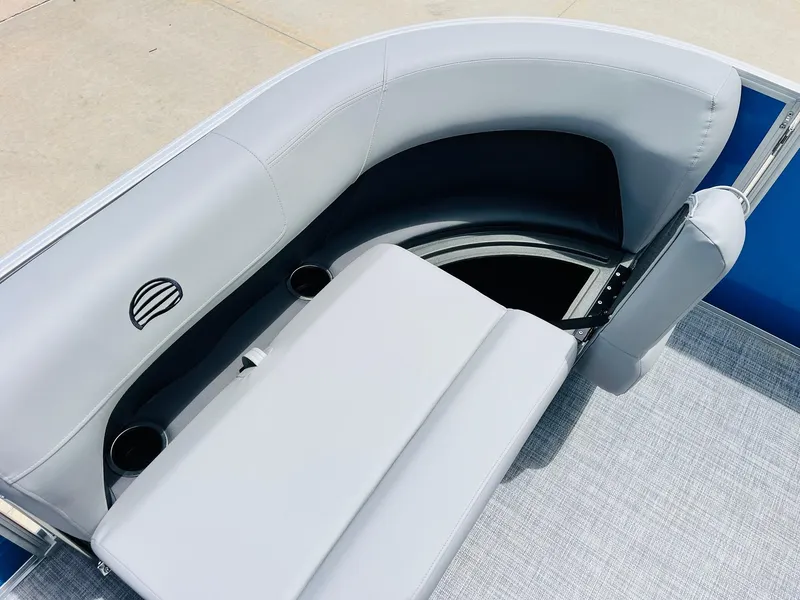 Slide: The Image of 2026 Sun Tracker Party Barge 16 DLX seating area with storage and cup holders. - 19