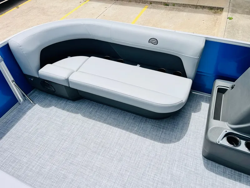 Slide: The Image of 2026 Sun Tracker Party Barge 16 DLX interior with gray seating and cup holders. - 21