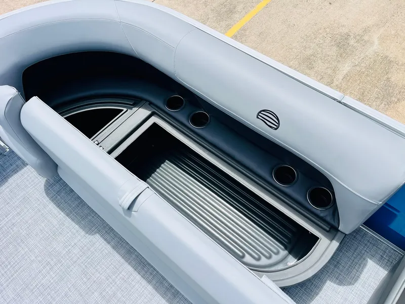 Slide: The Image of 2026 Sun Tracker Party Barge 16 DLX seating area with cup holders and storage. - 25