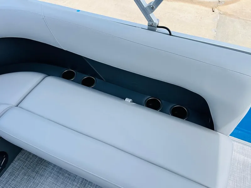 Slide: The Image of 2026 Sun Tracker Party Barge 16 DLX interior with cushioned seating and cup holders. - 27