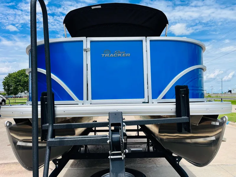 Slide: The Image of 2026 Sun Tracker Party Barge 16 DLX pontoon boat on trailer, blue exterior. - 3