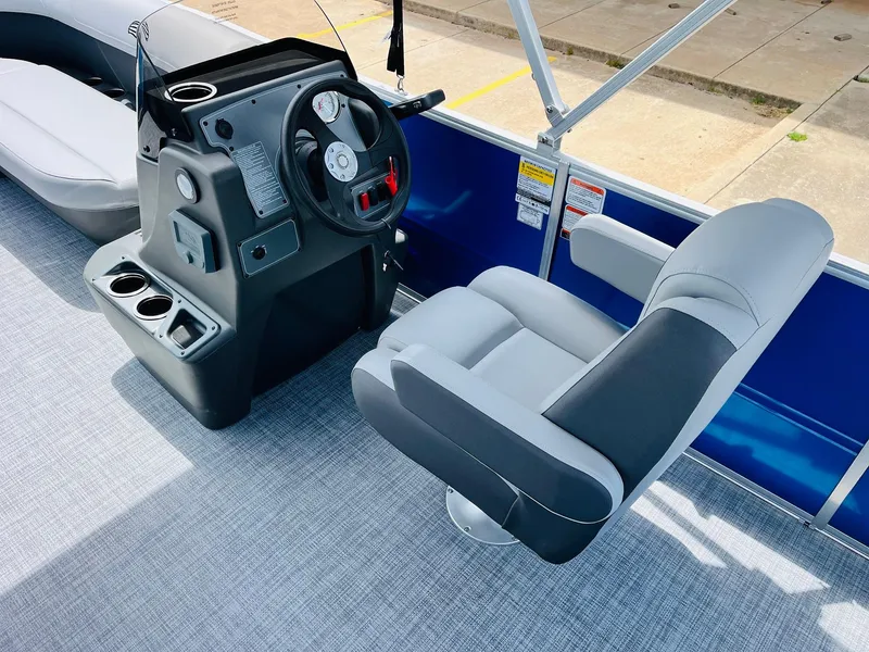 Slide: The Image of 2026 Sun Tracker Party Barge 16 DLX interior with steering console and seating. - 33