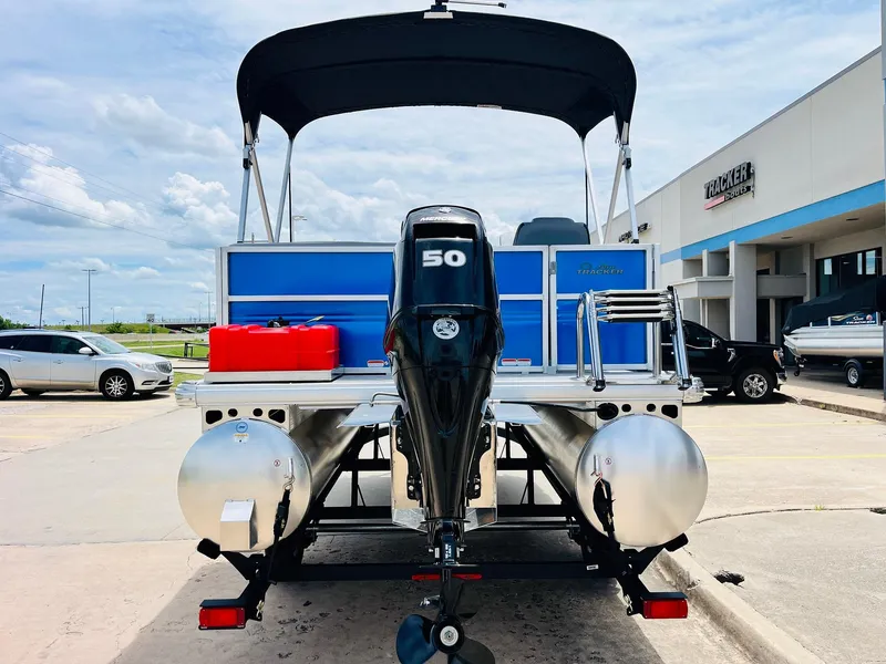 Slide: The Image of 2026 Sun Tracker Party Barge 16 DLX pontoon boat with 50 HP motor, parked outdoors. - 7