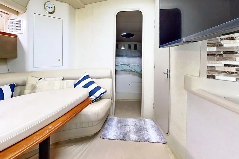 Slide: The Image of Interior of 1998 Cruisers Yachts 4270 Express with cozy seating and modern decor. - 12