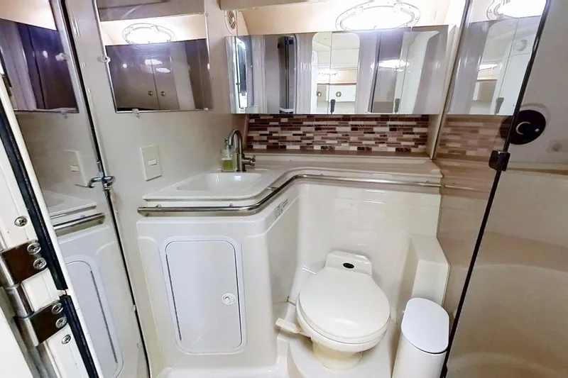 Slide: The Image of 1998 Cruisers Yachts 4270 Express bathroom with modern fixtures and stylish backsplash. - 14