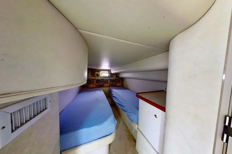 Slide: The Image of 1998 Cruisers Yachts 4270 Express cabin with twin beds and storage. - 16