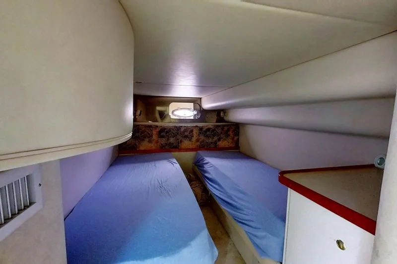 Slide: The Image of 1998 Cruisers Yachts 4270 Express cabin with twin beds and compact design. - 17