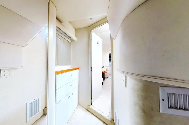 Slide: The Image of Interior of 1998 Cruisers Yachts 4270 Express, featuring white cabinetry and modern design. - 18