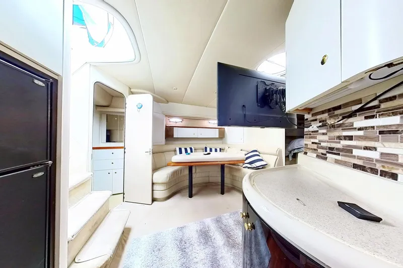 Slide: The Image of Interior of 1998 Cruisers Yachts 4270 Express, featuring a cozy dining area and modern amenities. - 22