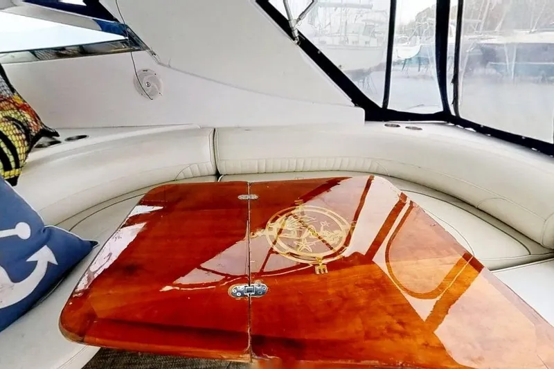 Slide: The Image of Luxurious interior of 1998 Cruisers Yachts 4270 Express with polished wooden table. - 25