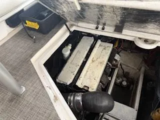 Slide: The Image of 1998 Cruisers Yachts 4270 Express engine compartment with visible components and storage area. - 30