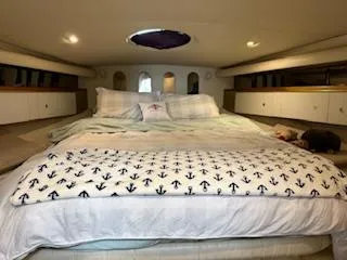 Slide: The Image of Cozy bedroom in 1998 Cruisers Yachts 4270 Express with nautical-themed bedding. - 8