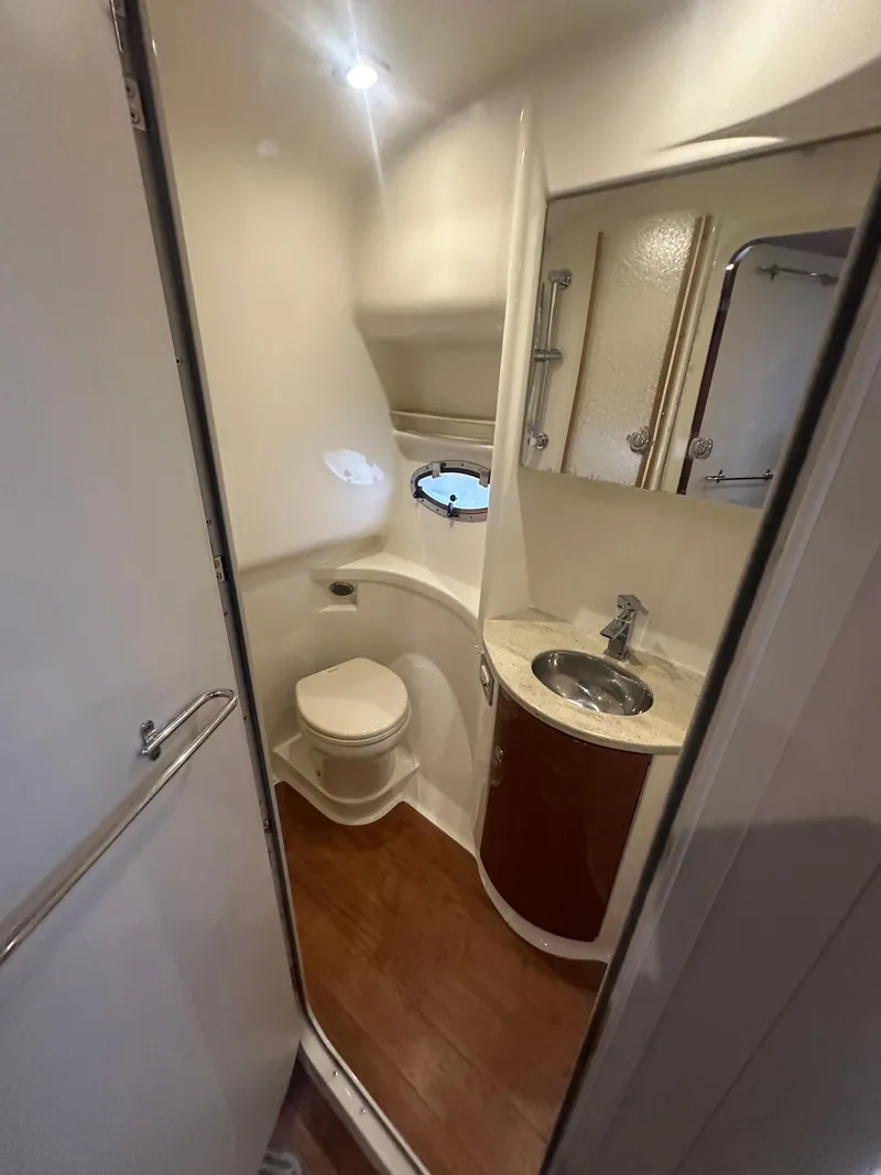 Slide: The Image of 2013 Formula 37 PC yacht bathroom with toilet, sink, and porthole window. - 20