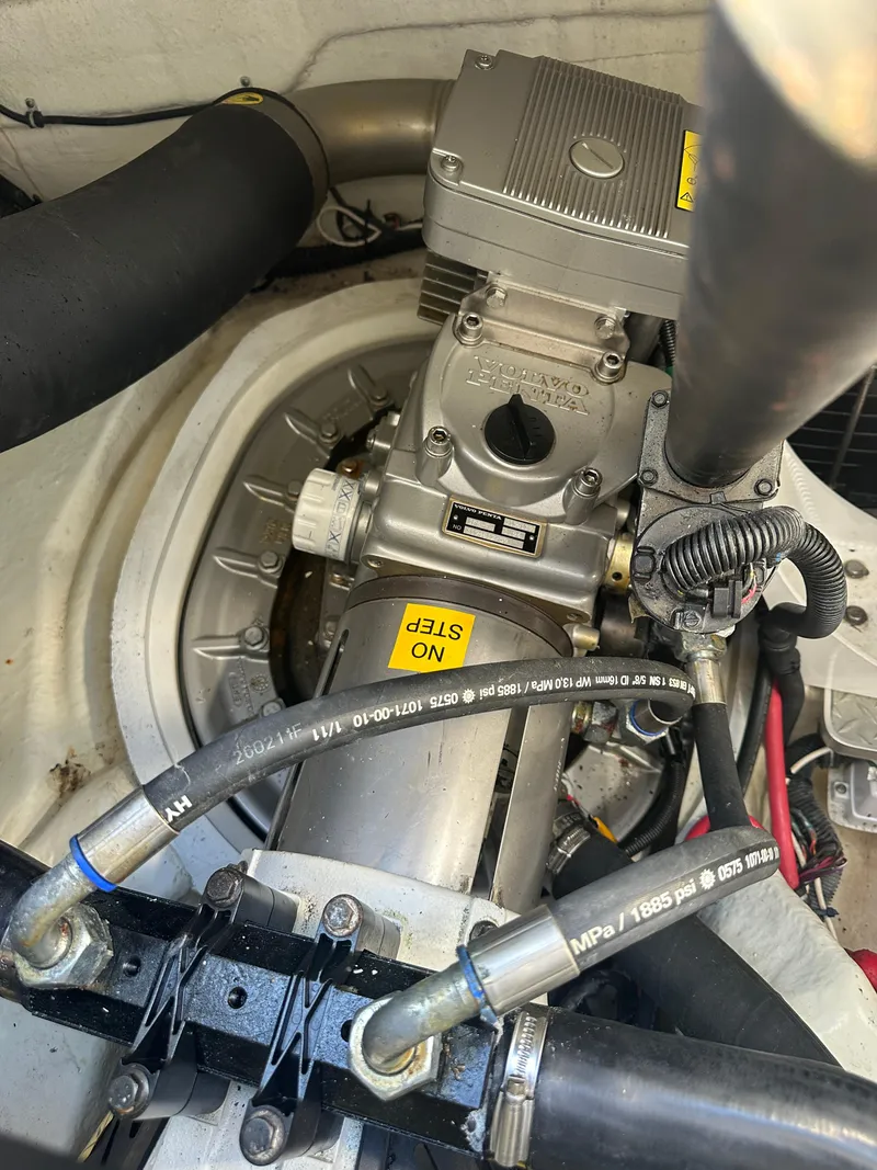 Slide: The Image of Engine compartment of a 2013 Formula 37 PC boat, featuring mechanical components and hoses. - 25