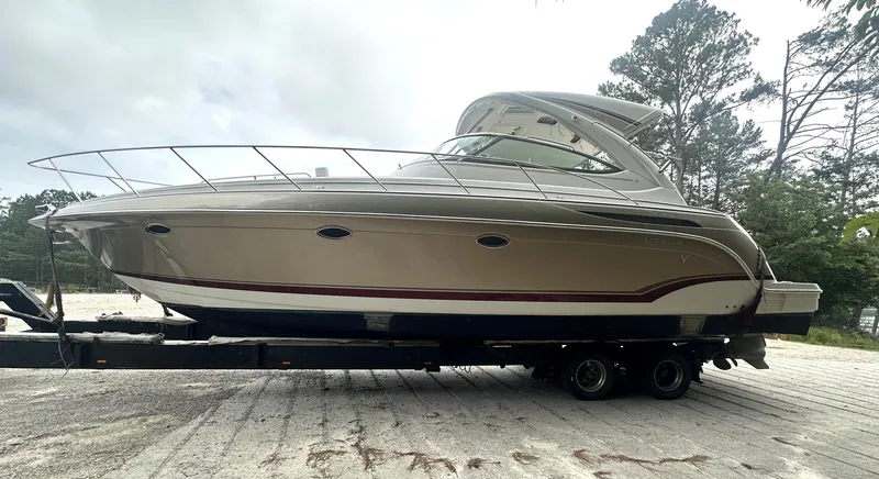 Slide: The Image of 2013 Formula 37 PC yacht on trailer, parked outdoors with trees in background. - 31