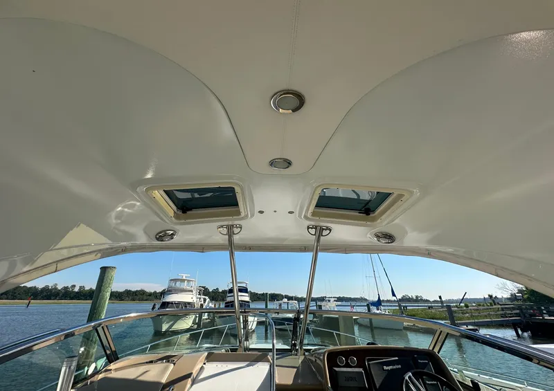 Slide: The Image of 2013 Formula 37 PC yacht interior view with open sunroof and steering console. - 4