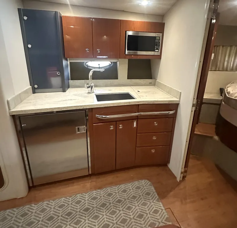 Slide: The Image of 2013 Formula 37 PC yacht kitchen with modern appliances and wood cabinetry. - 7